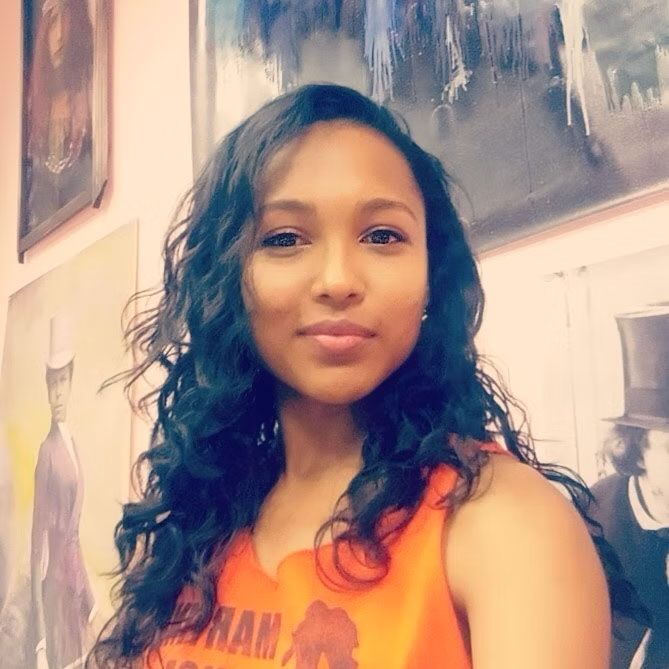 A woman wearing an orange tank top with the word ham on it