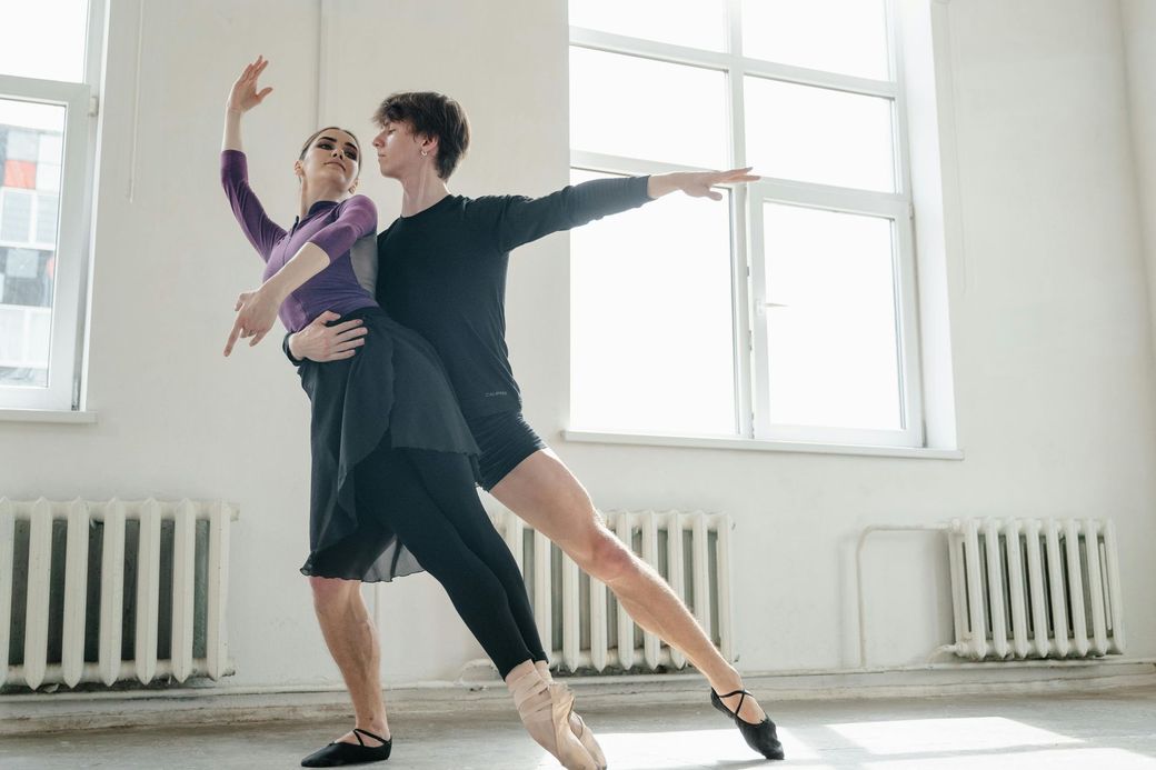 A group of people are dancing in a dance studio.