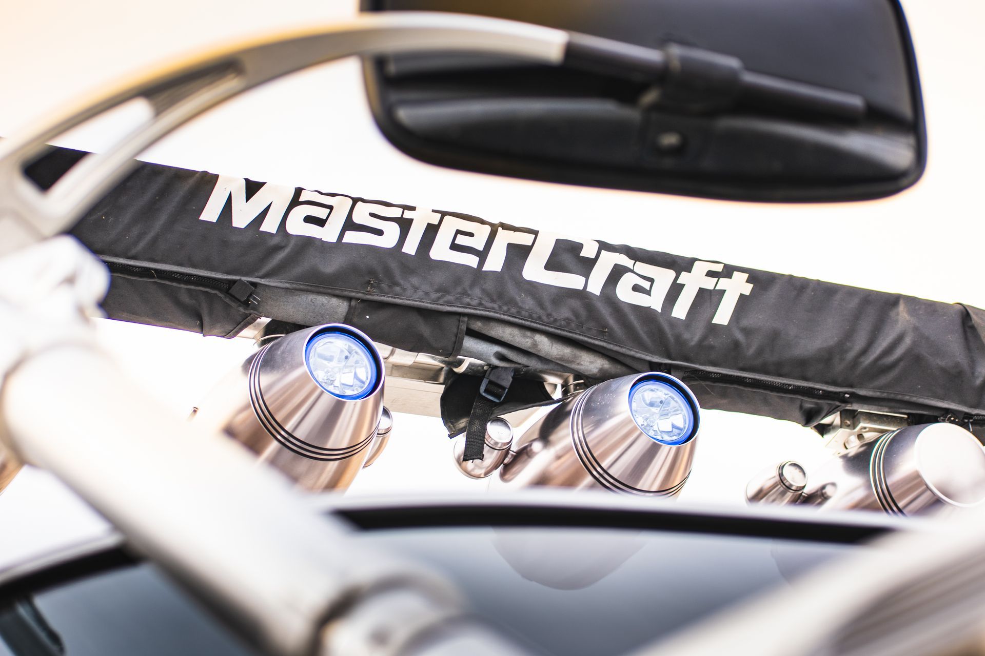 MasterCraft boat with the brand name on top, two lights and a side mirror.
