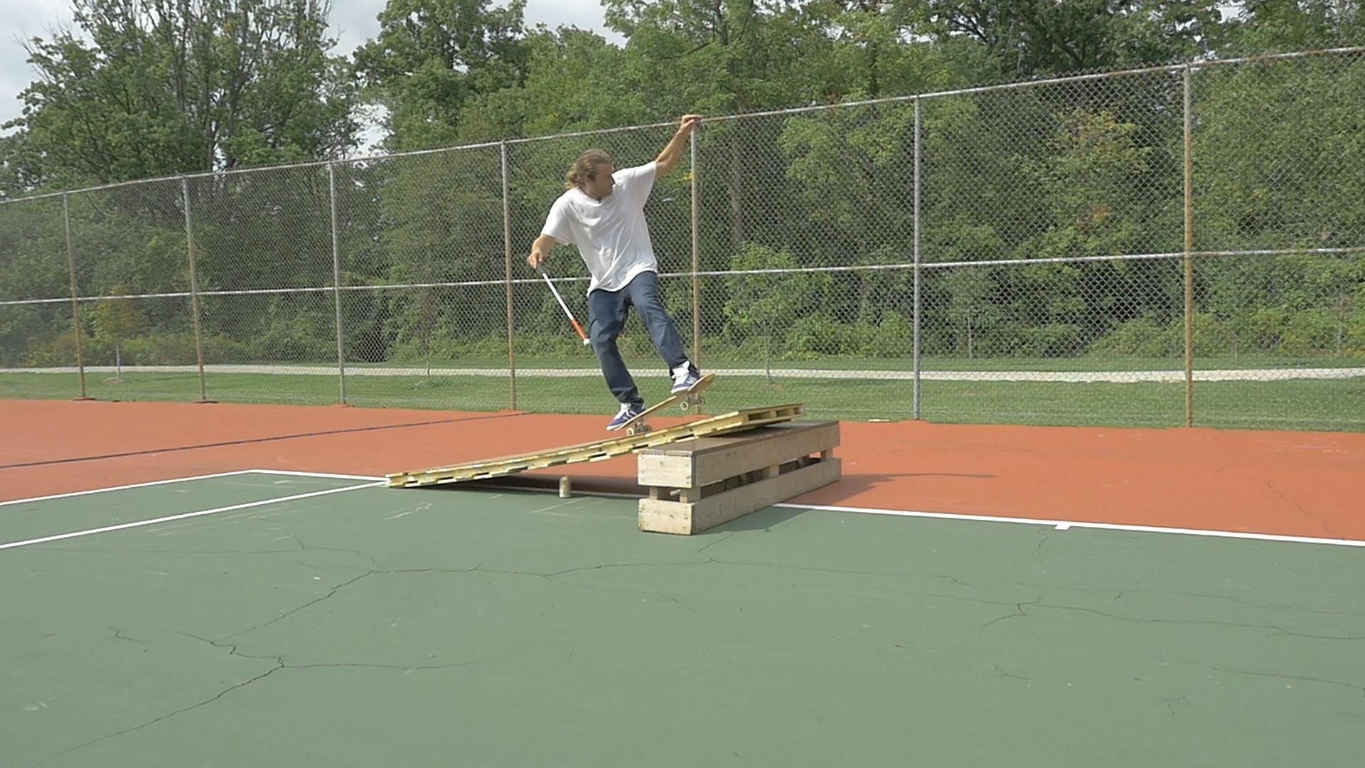 Dan manuals up a sketchy wooden ramp.