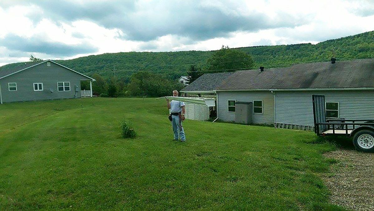 gutter contractor holding a gutter