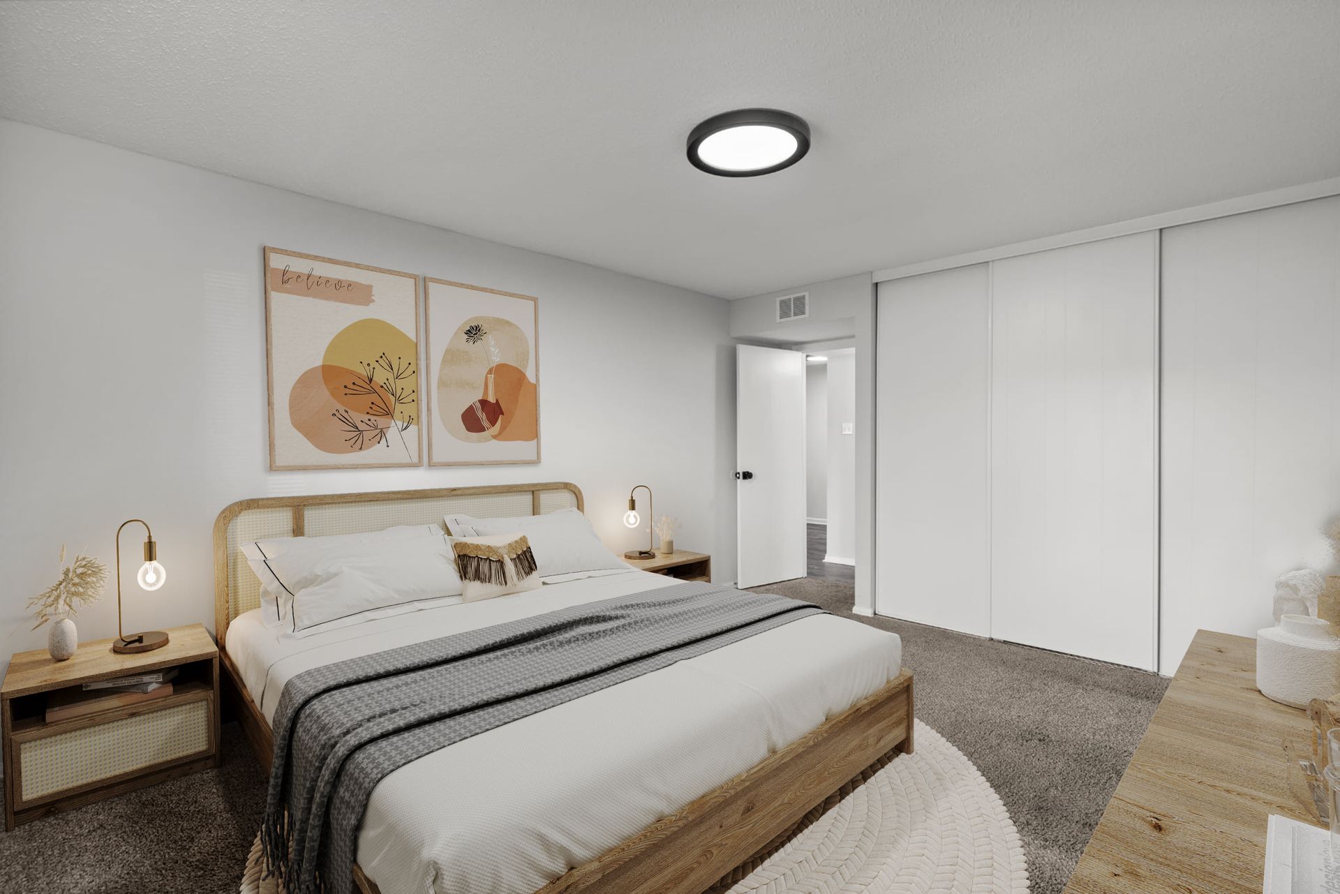 A bedroom with a large bed , dresser , nightstand , and sliding closet doors.