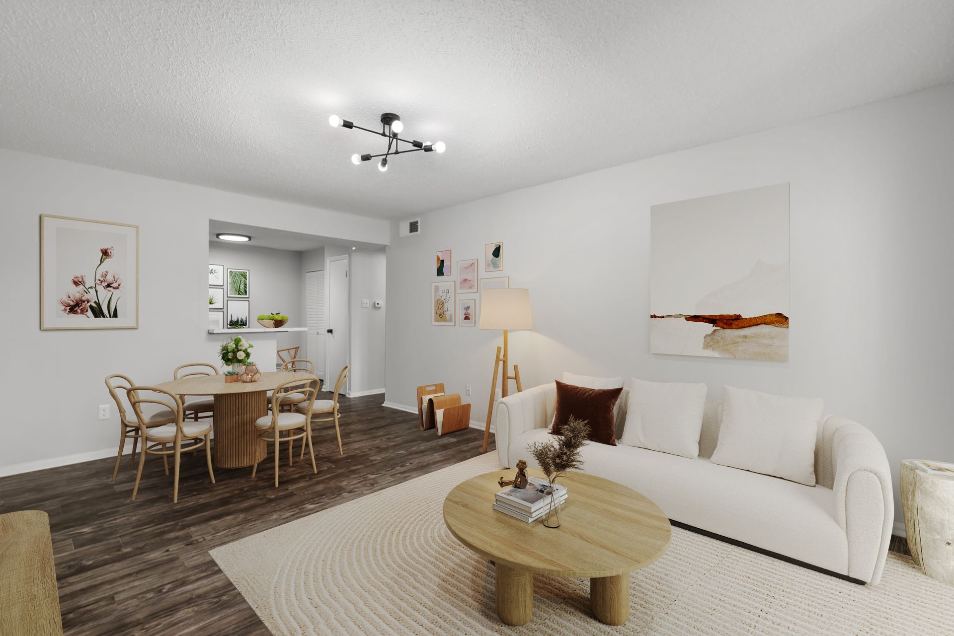 A living room with a couch , table and chairs.