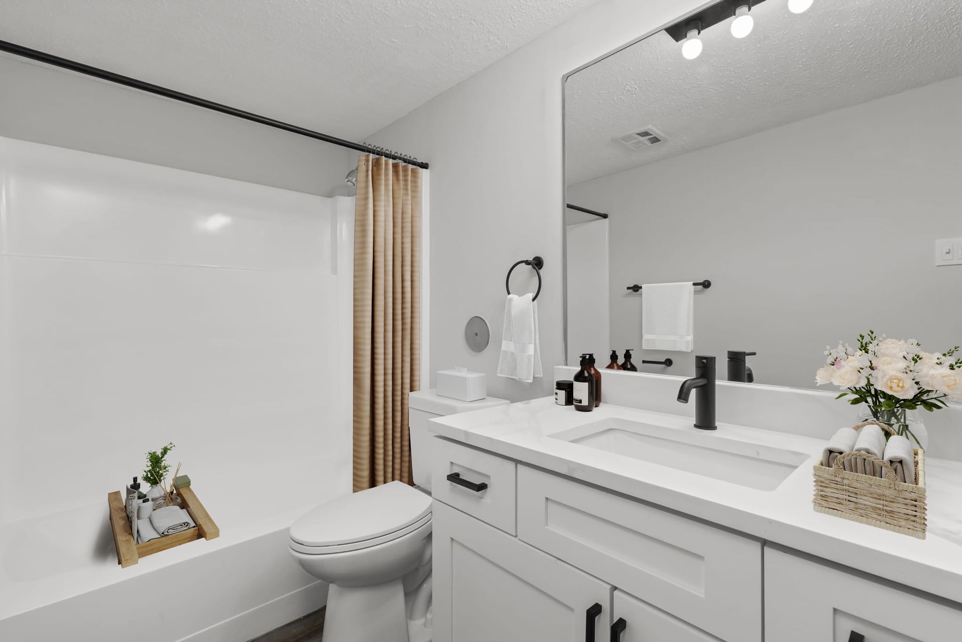 A bathroom with a toilet , sink , and mirror.
