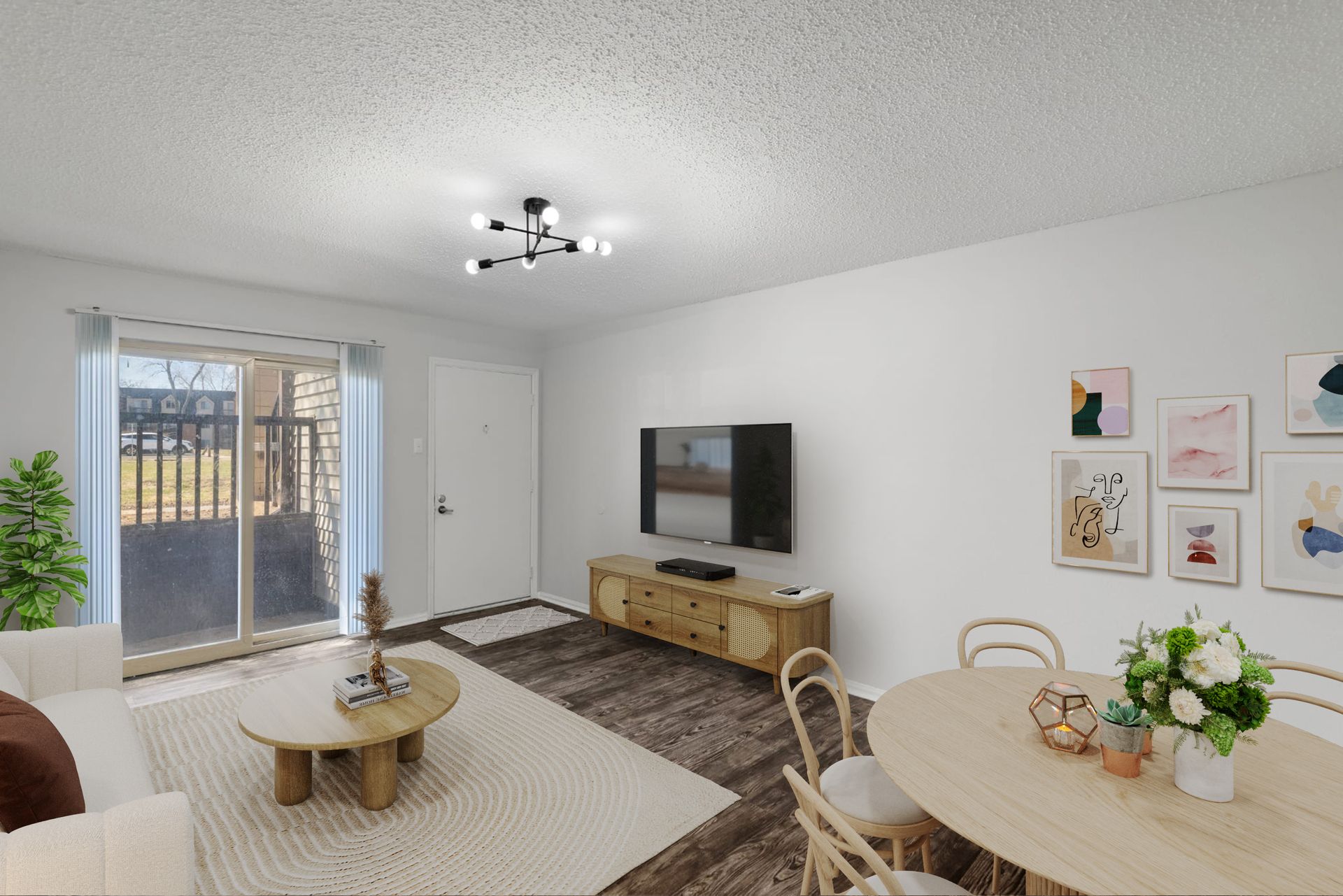 A living room with a couch , table , chairs and a flat screen tv.