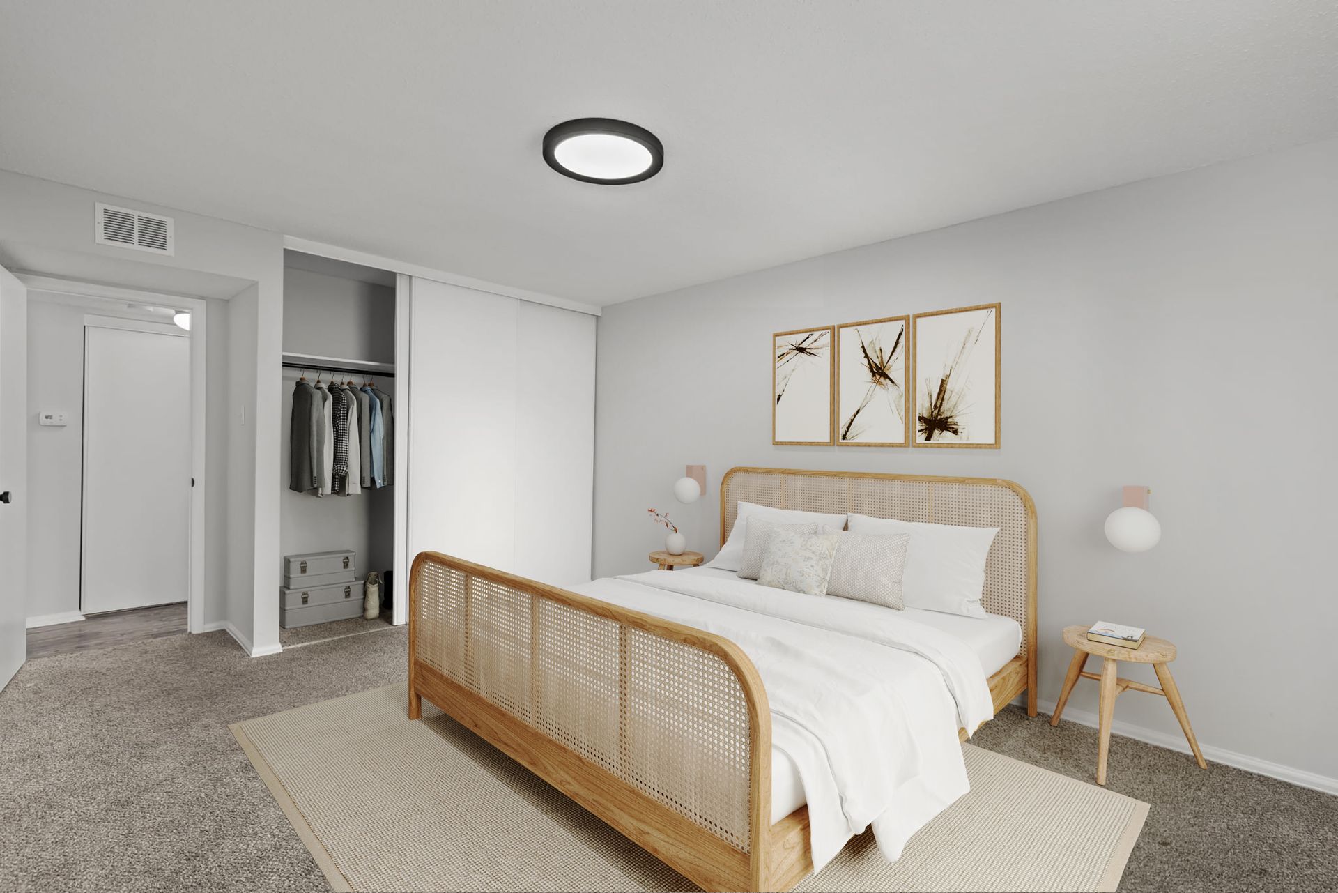 A bedroom with a large bed and a walk in closet.