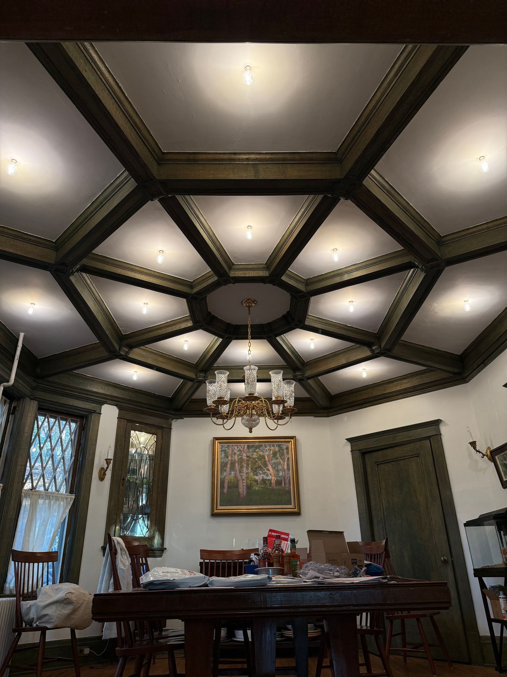 Round jacuzzi on a wooden platform in a room with a window, curtains, and wooden ceiling.