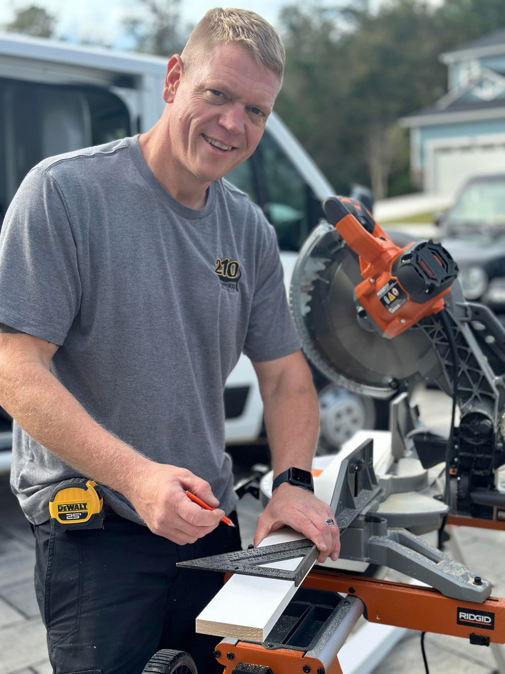 Paul Stratton  is standing next to a circular saw cutting a piece of wood.