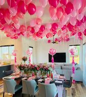 A room with pink balloons hanging from the ceiling