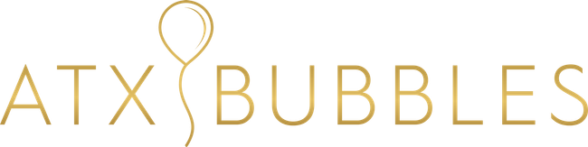 A gold logo for atx bubbles with a balloon in the middle.