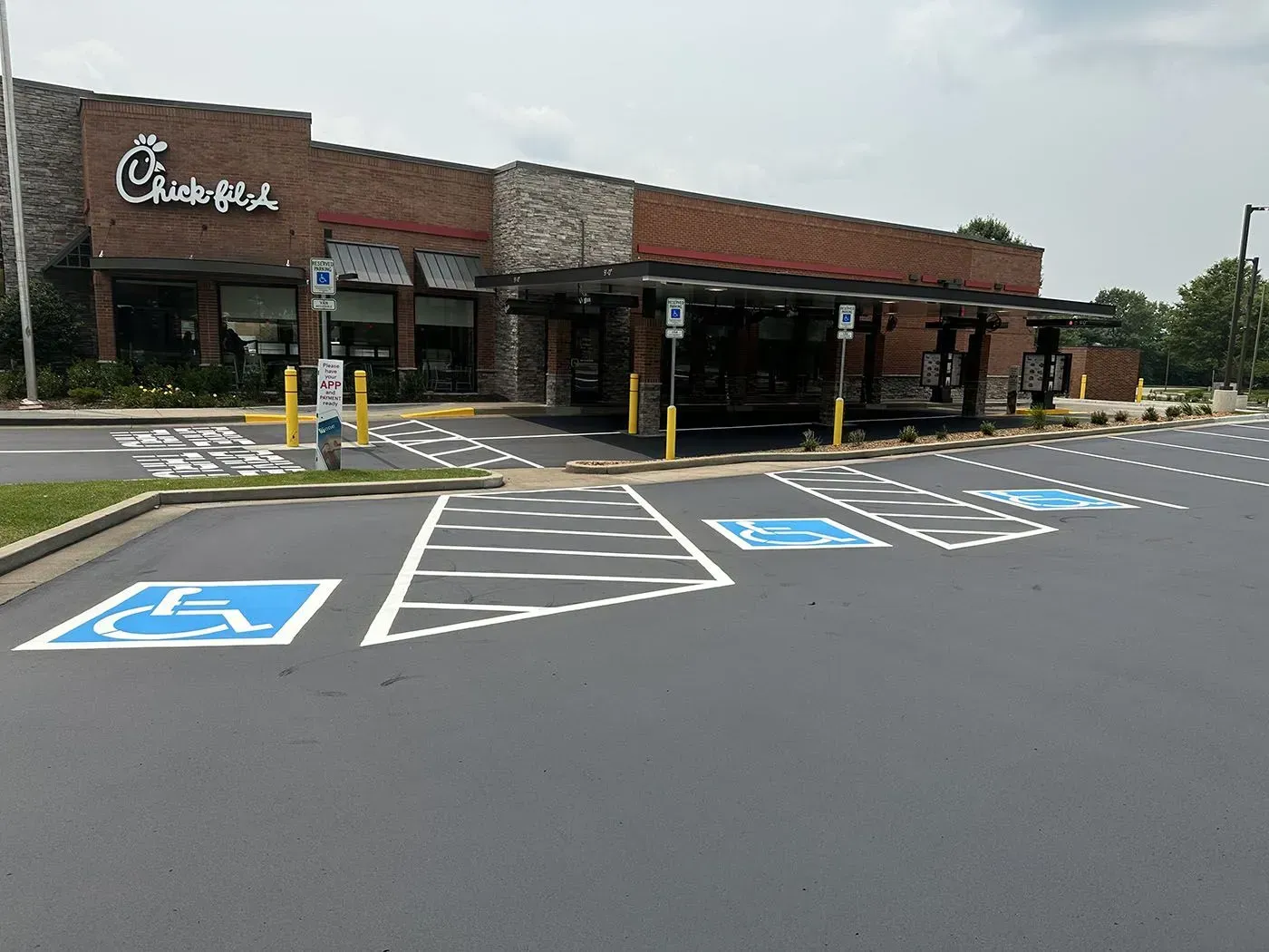 Exterior view of a Chick-fil-A restaurant with accessible parking spaces marked with blue wheelchair symbols.