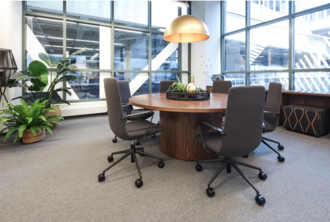 A conference room with a round table and chairs