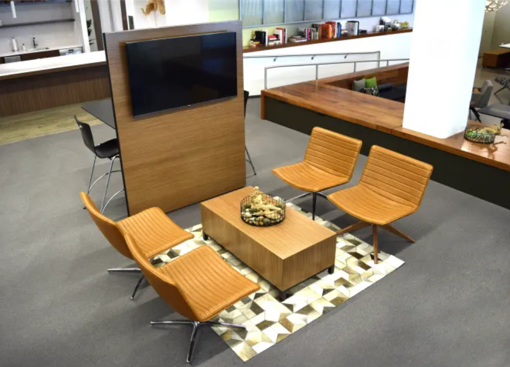 A living room with chairs a coffee table and a flat screen tv