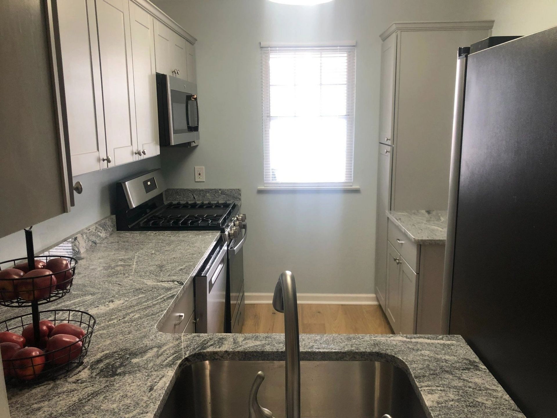 A kitchen with stainless steel appliances and granite counter tops