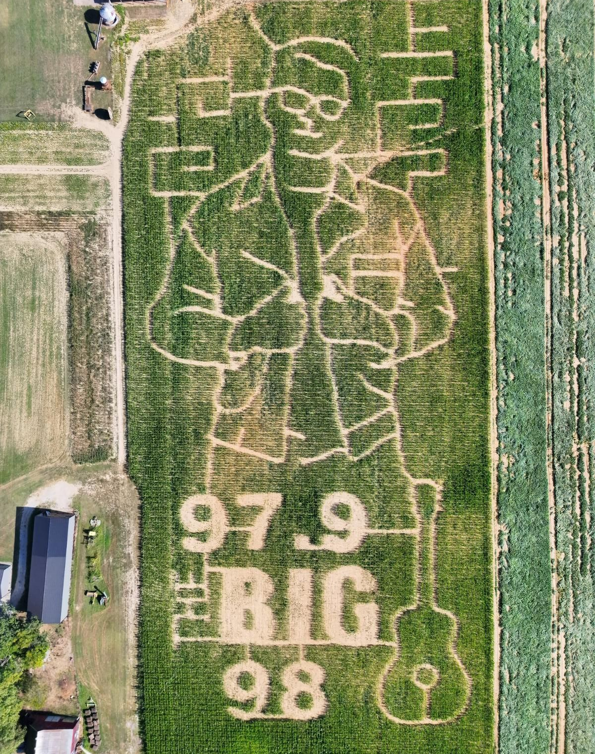 An aerial view of a corn maze in a field.
