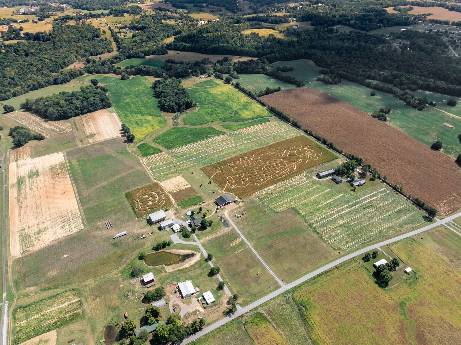 An aerial view of a farm with lots of fields and trees