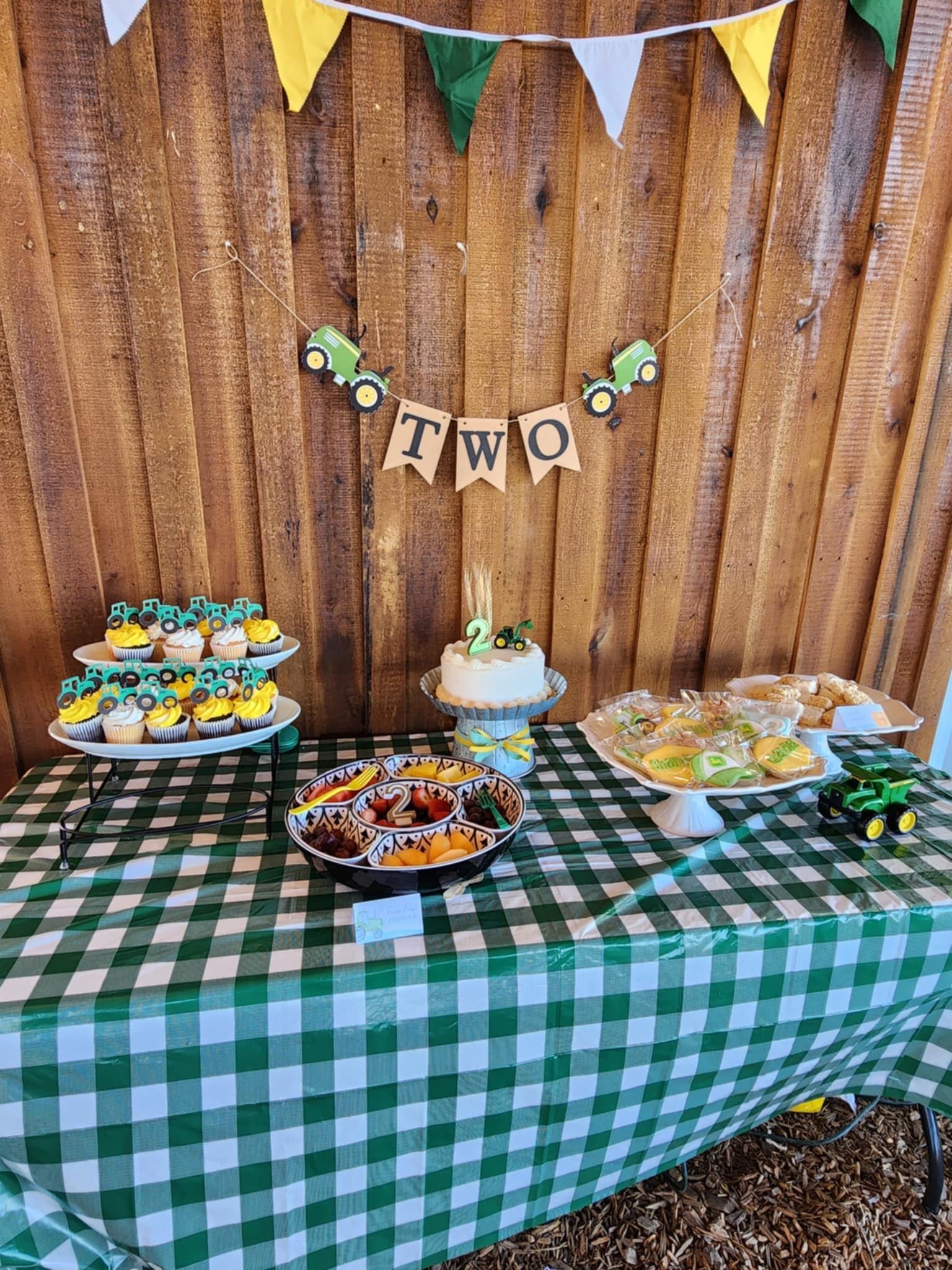 A table with a green and white checkered tablecloth and food on it.