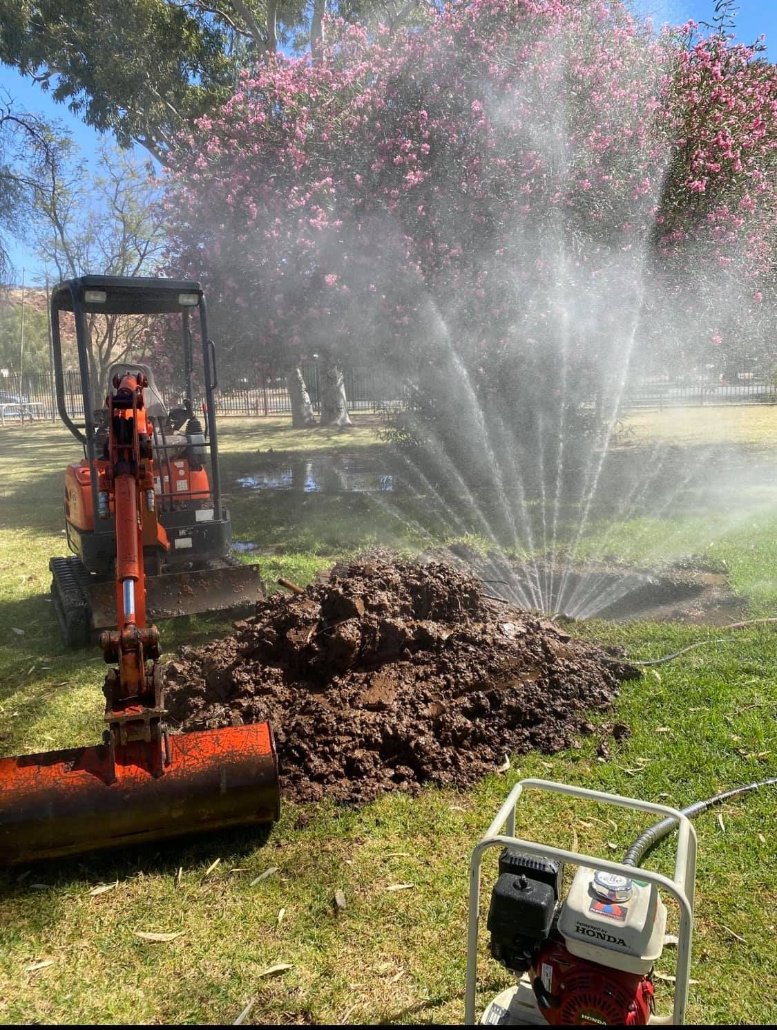 A Plumber Is Fixing A Water Leak in A Yard — Flavell Plumbing (NT) Pty Ltd In Ciccone, NT