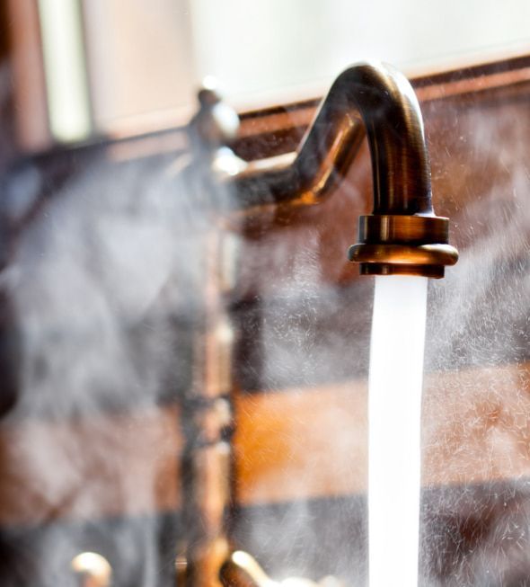 A Close Up Of A Faucet With Steam Coming Out Of It — Flavell Plumbing (NT) Pty Ltd In Ciccone, NT