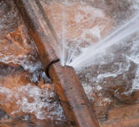 A Close Up Of A Broken Pipe With Water Coming Out Of It — Flavell Plumbing (NT) Pty Ltd In Ciccone, NT