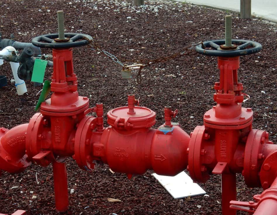 A Bunch Of Red Pipes With Valves On Them — Flavell Plumbing (NT) Pty Ltd In Ciccone, NT