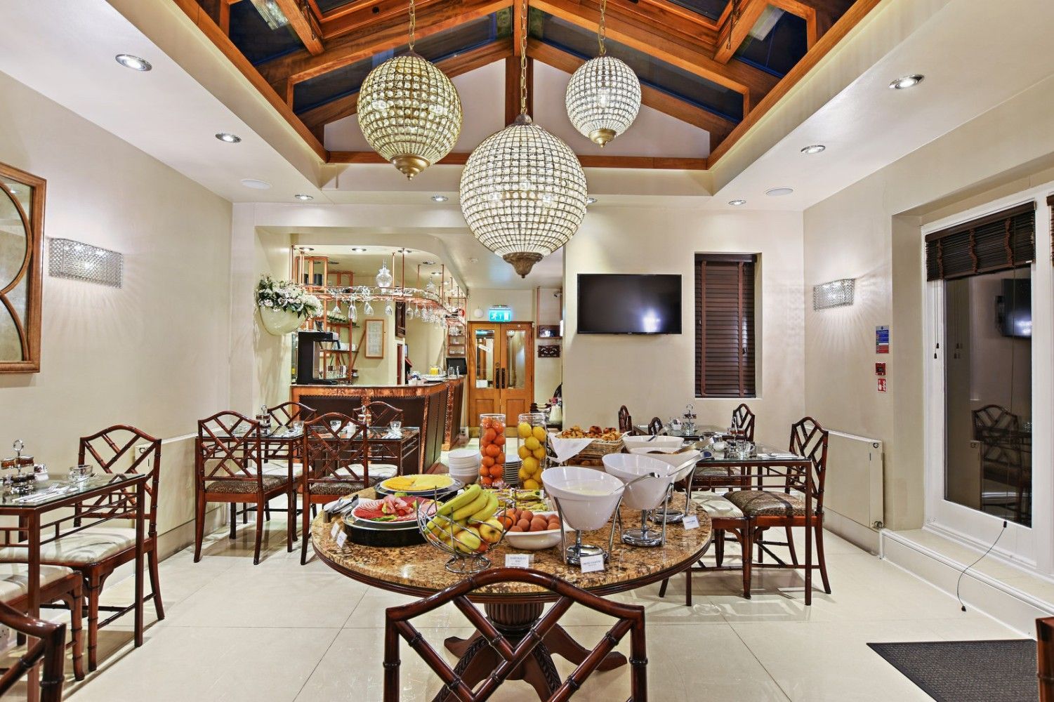 Breakfast room with a buffet table and chandelier lighting.