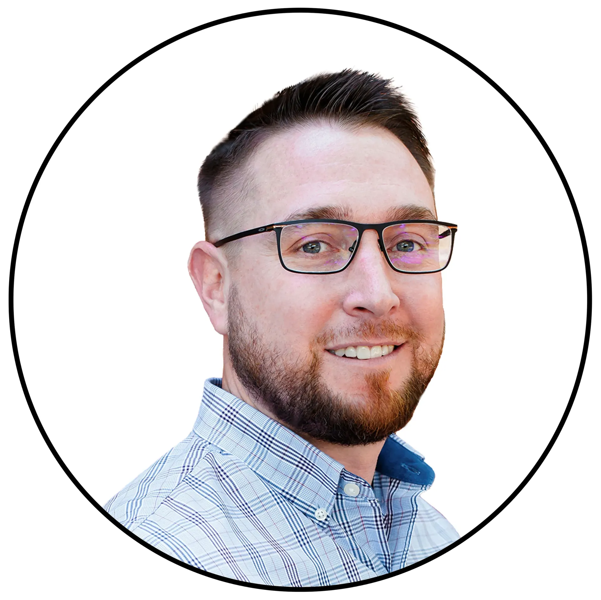 Man with glasses, short brown hair, and beard, smiling. Wearing a plaid shirt.