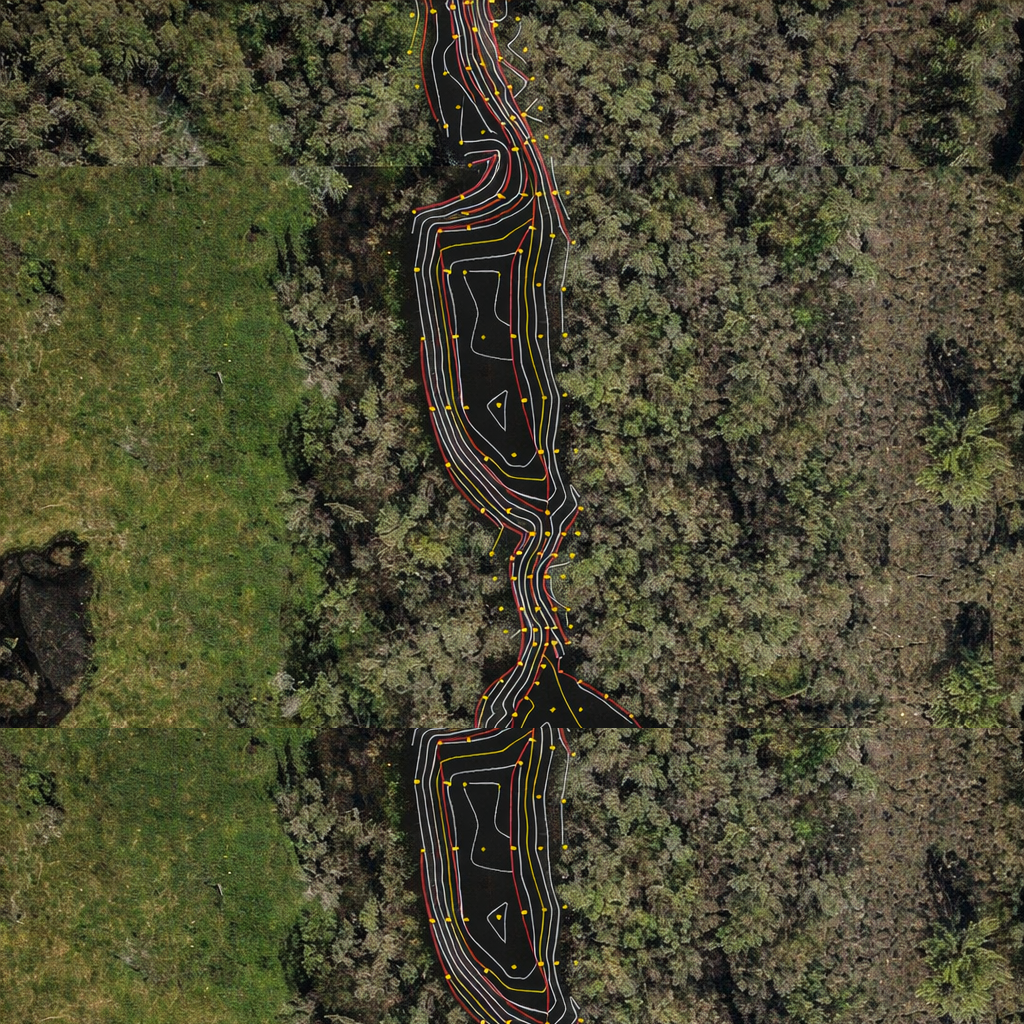 Aerial view of a winding waterway, with marshy vegetation on either side and a lighter-colored path overlaid.