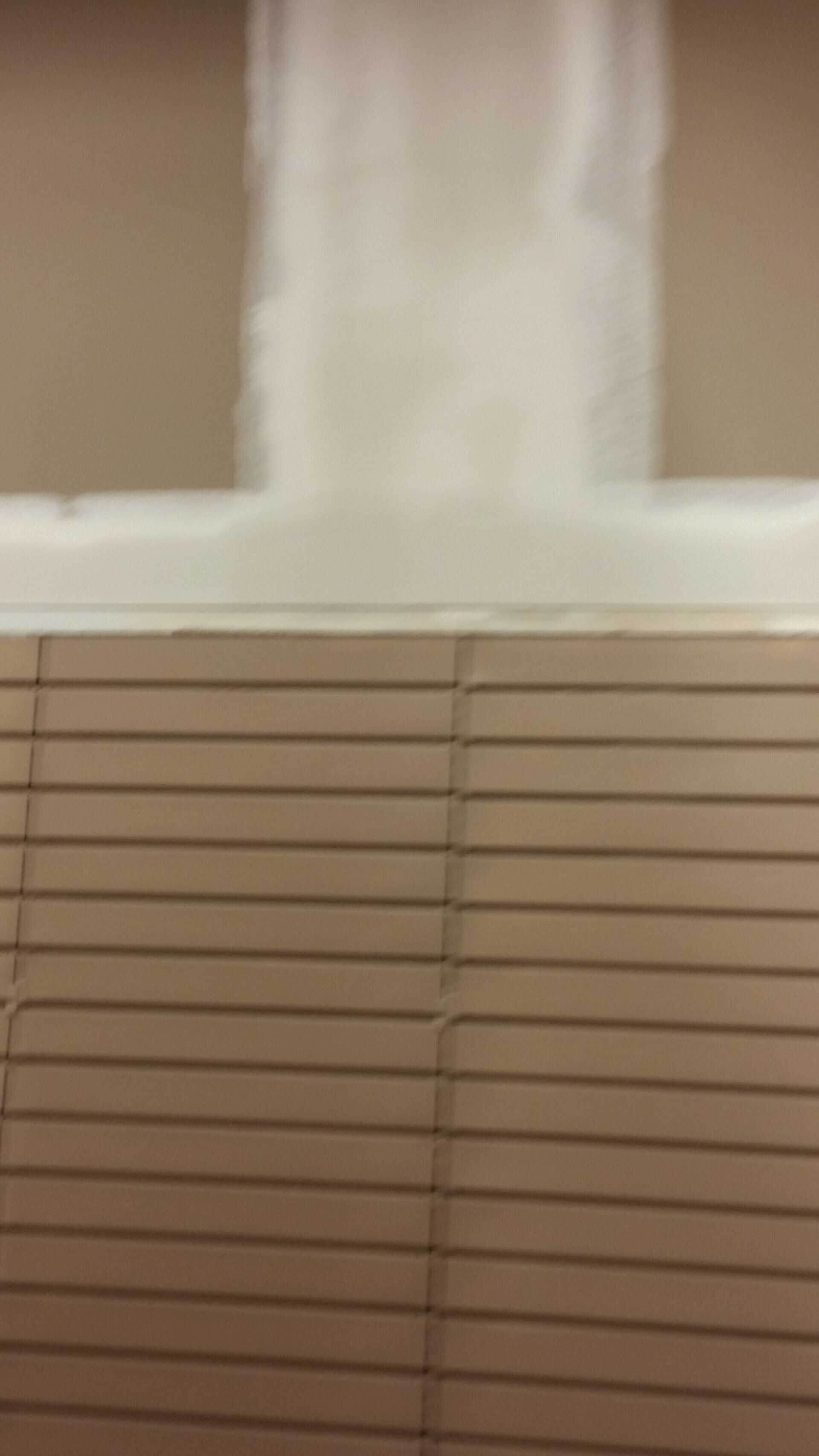 A close up of a wall with blinds on it