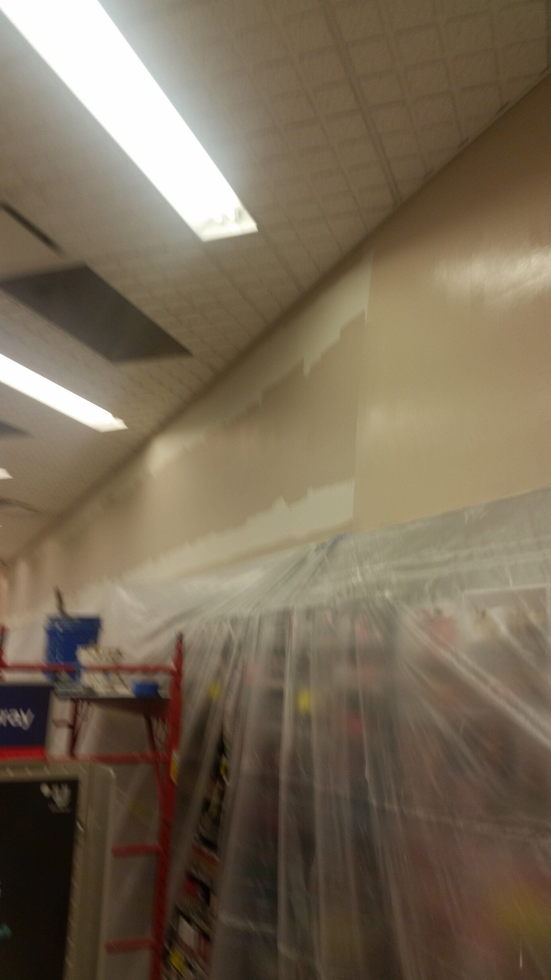 A room is being painted and covered in plastic.