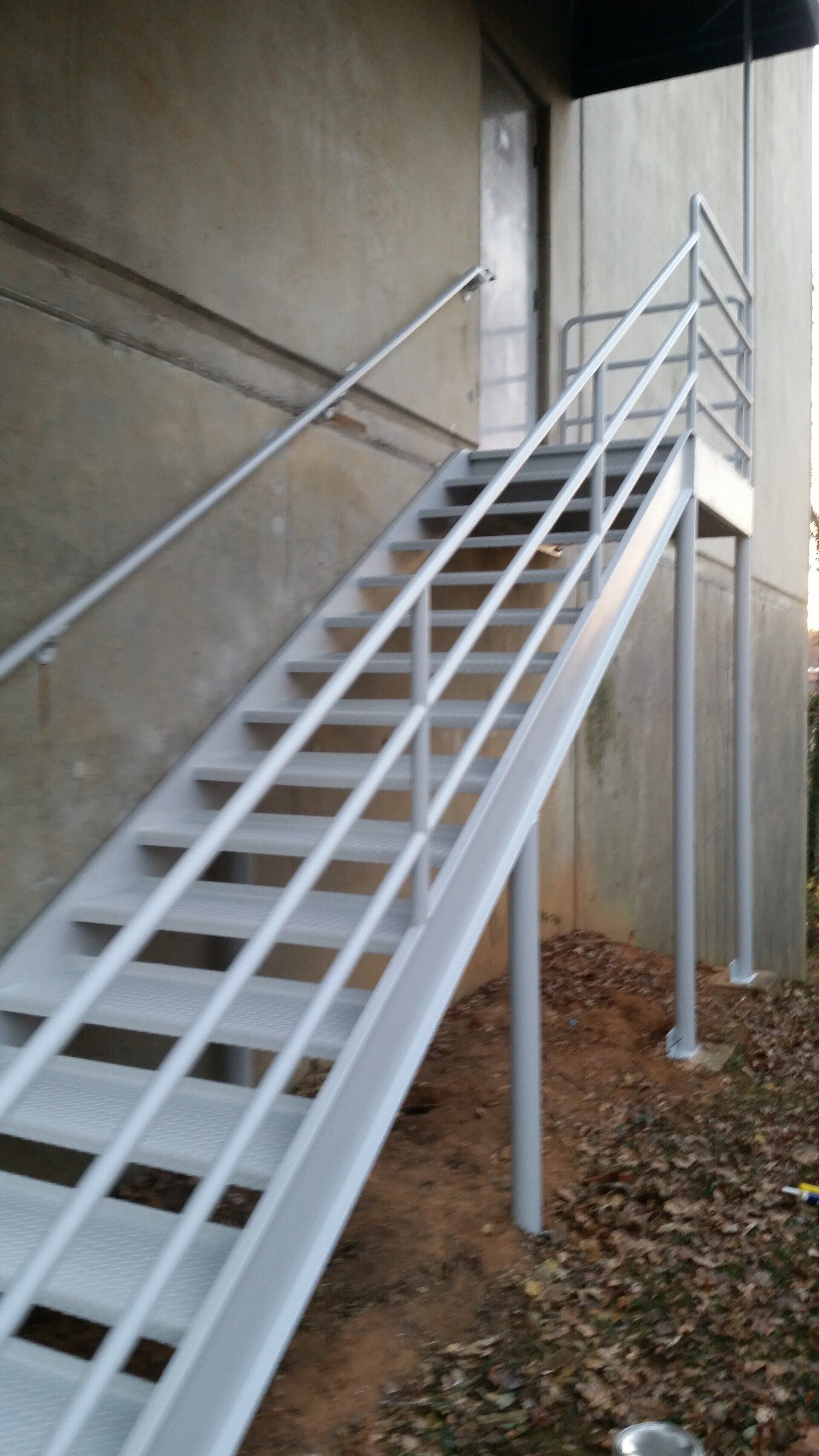 A set of stairs leading up to a building with a metal railing