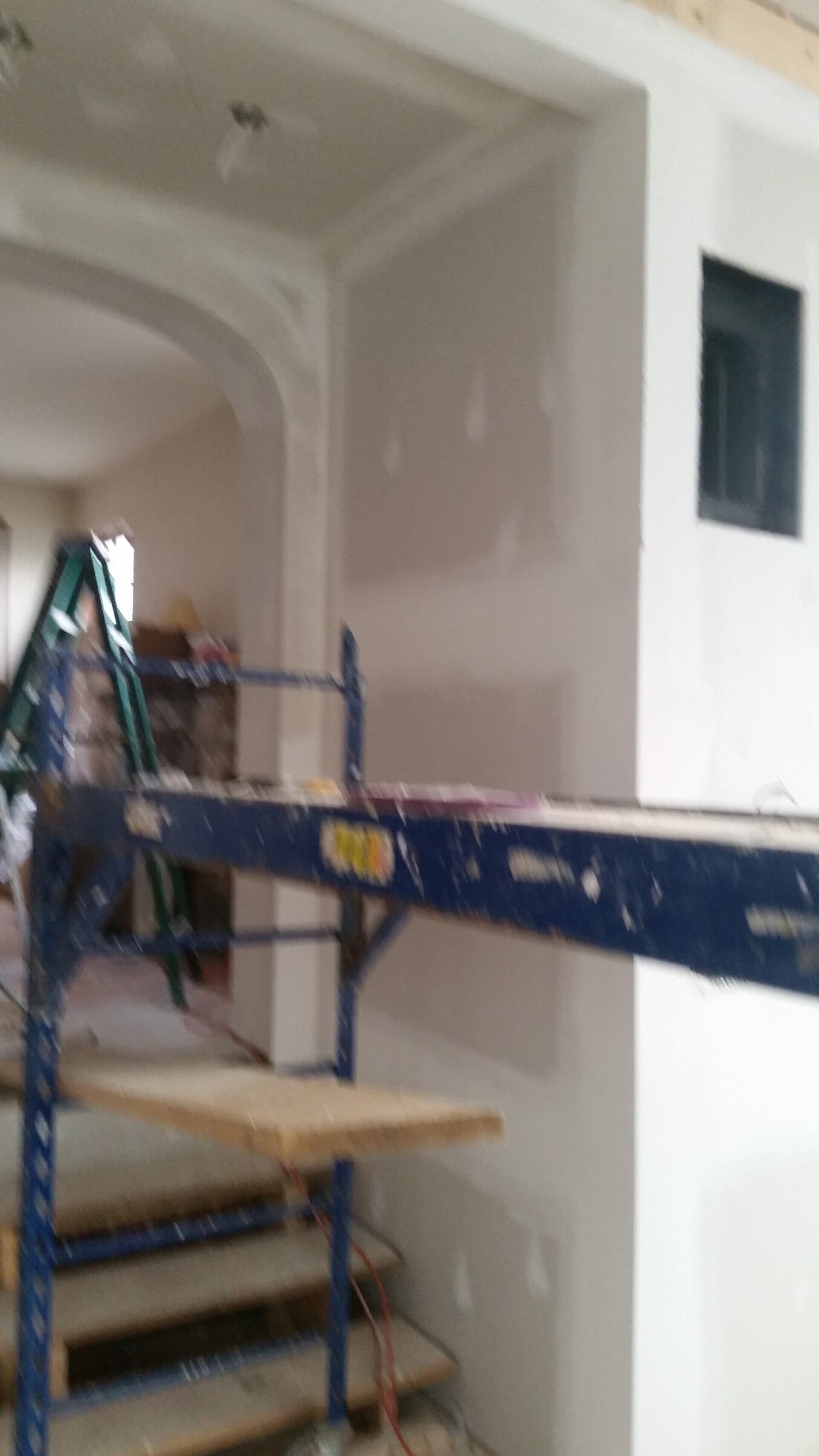 A ladder is sitting on top of a scaffolding in a room.