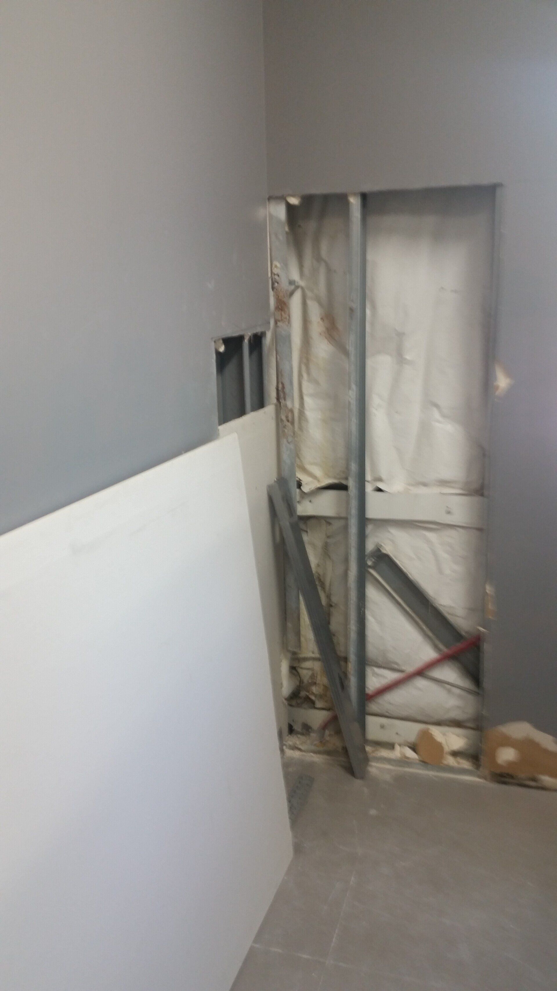 There is a hole in the wall in the middle of the room.