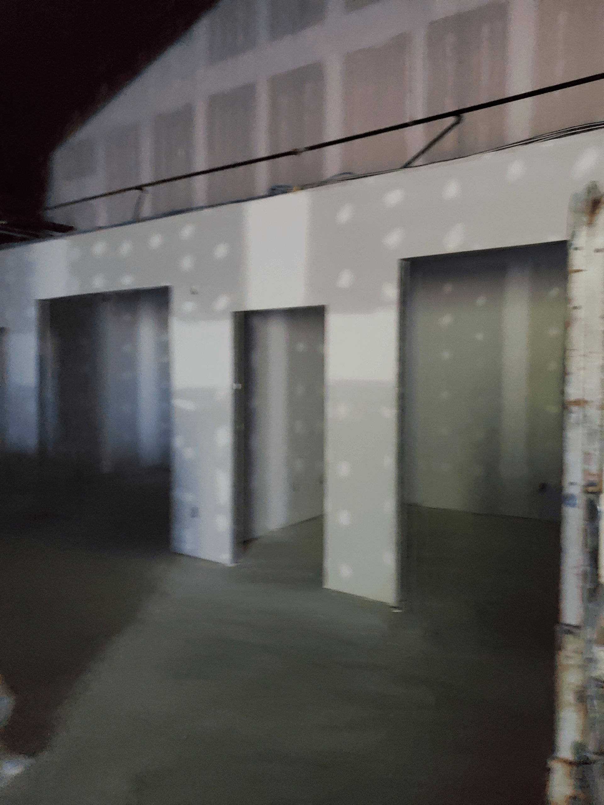 A room with a lot of white walls and doors