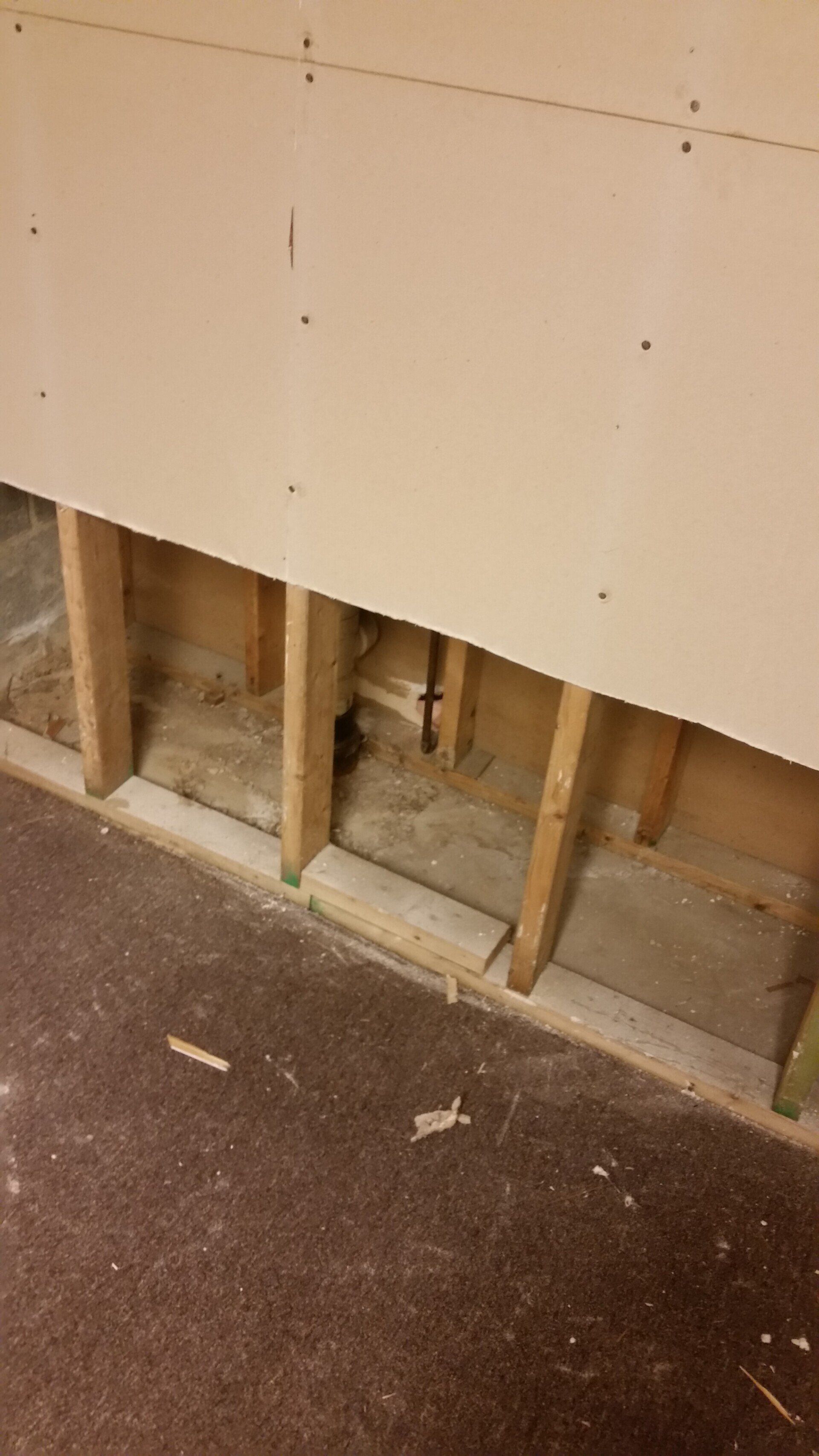 A room with a wooden wall and a wooden floor.