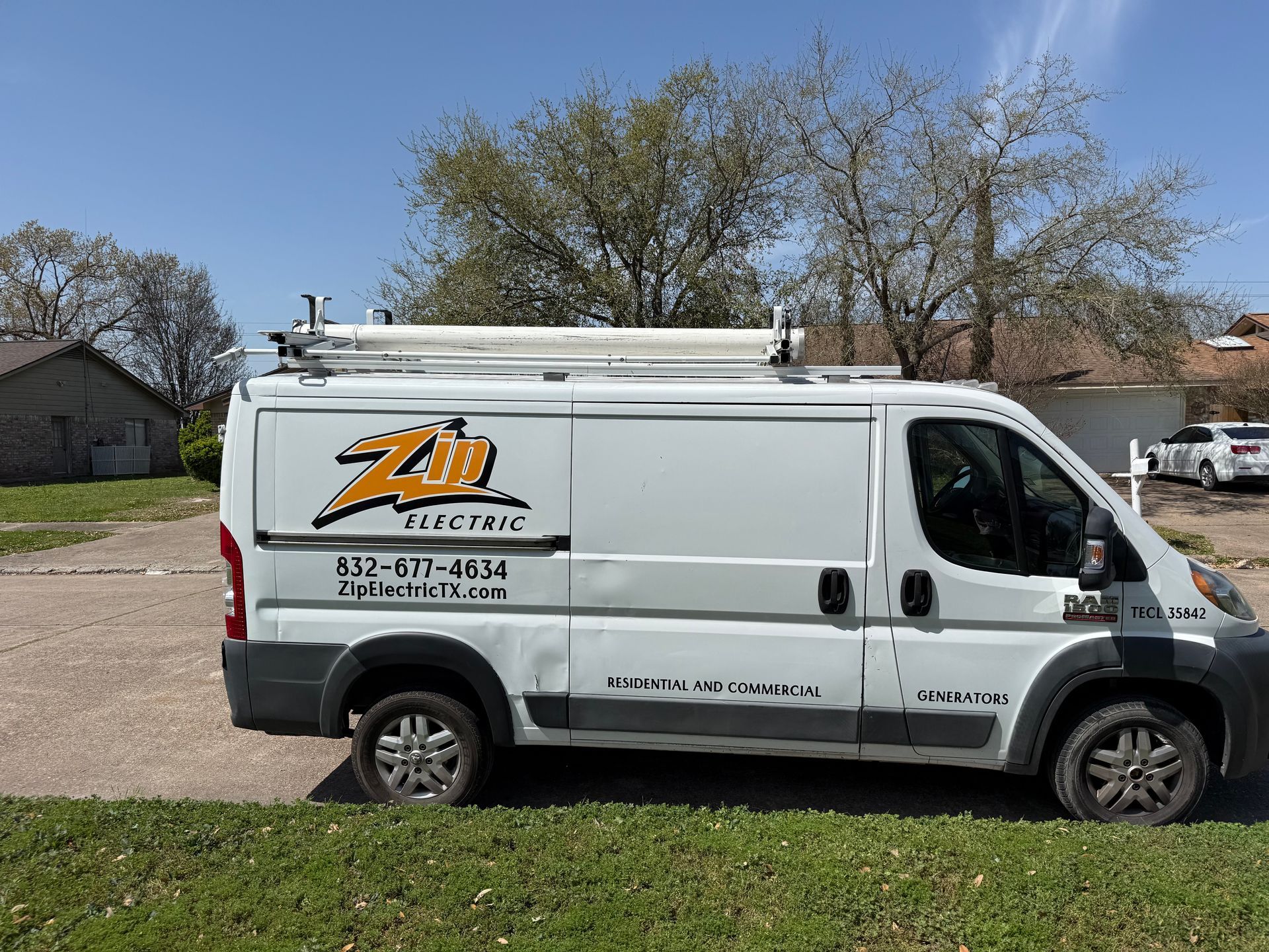 White ZB Electric van parked on a green lawn; sunny day.