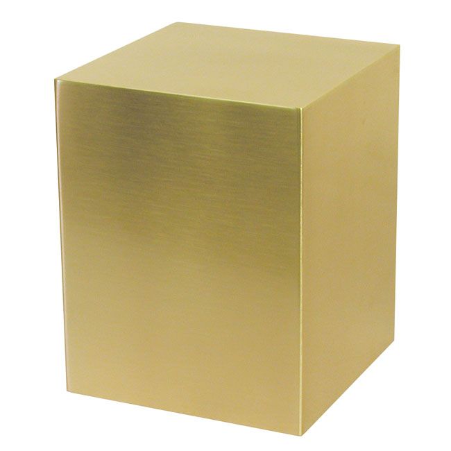 A gold cube is sitting on a white surface