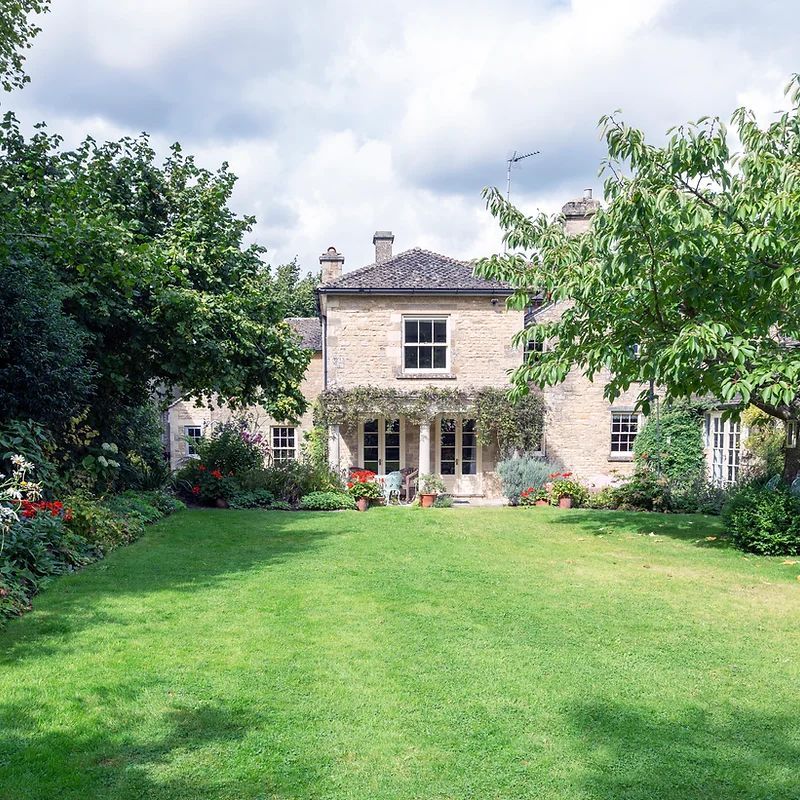 A large house with a lush green lawn in front of it