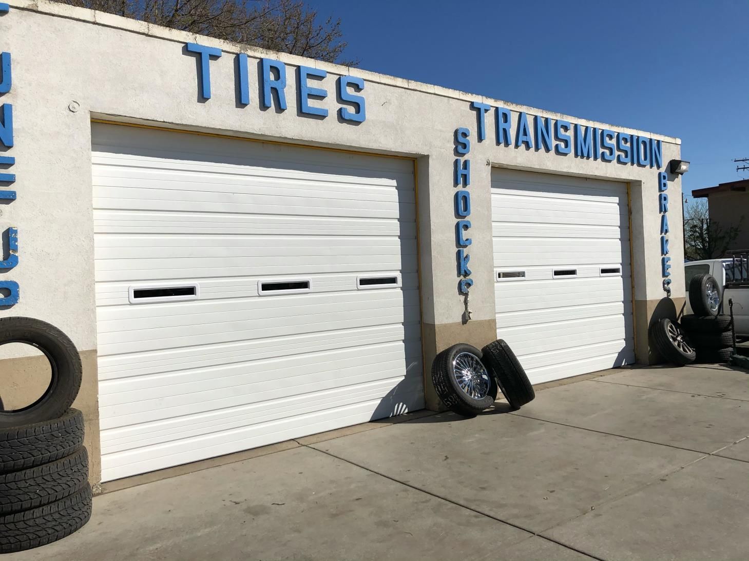 Tires and transmission are written on the side of a building