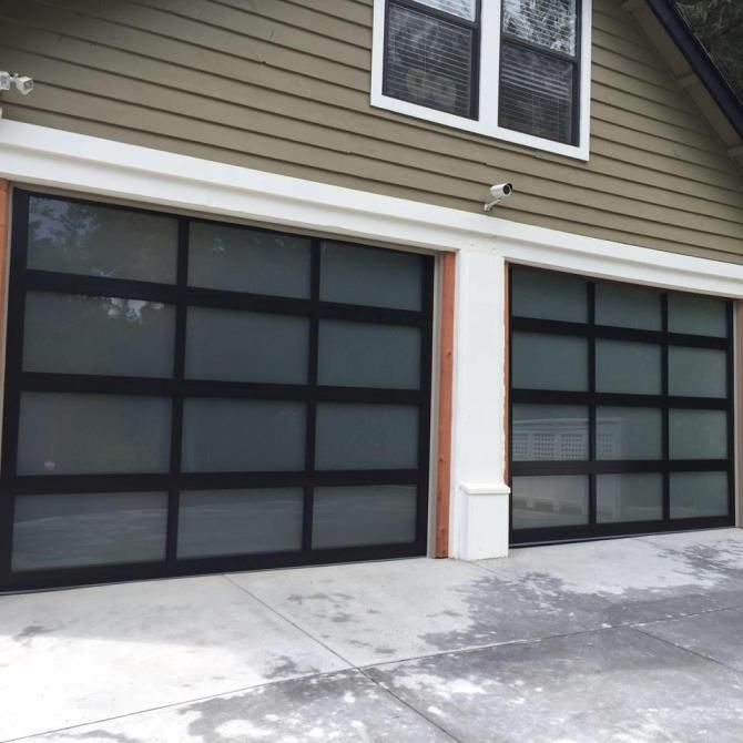 A house with two garage doors and two windows