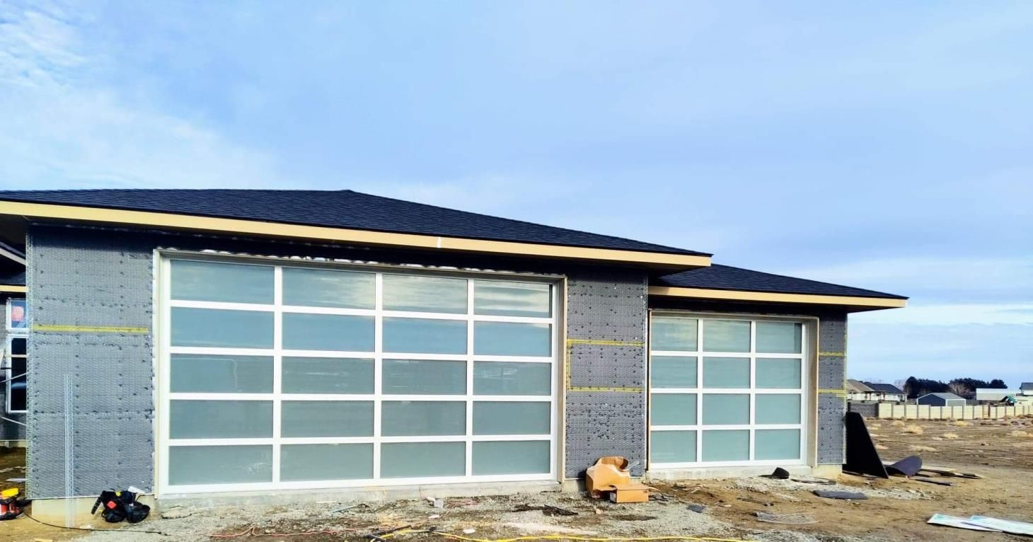 A house is being built with a large garage door.