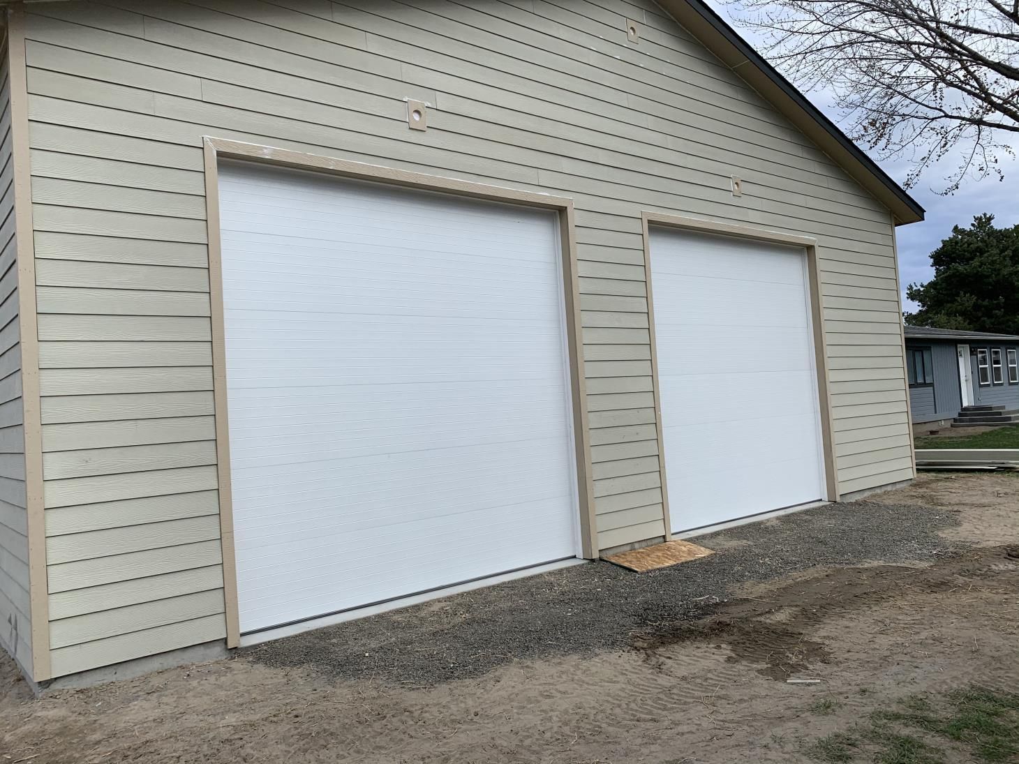 A white garage with two white garage doors