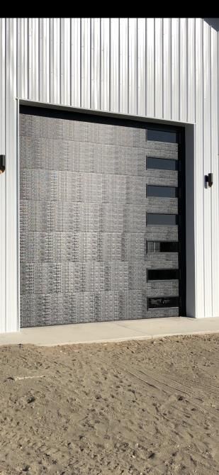 A garage door is open on a white building.