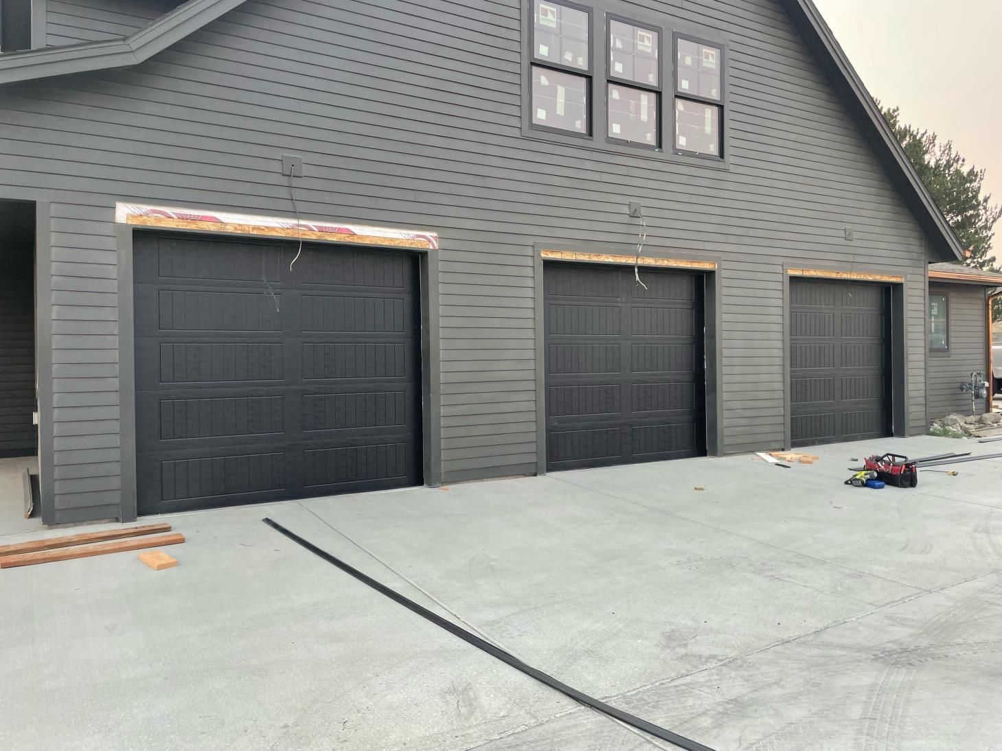 A garage door is being installed on the side of a building.
