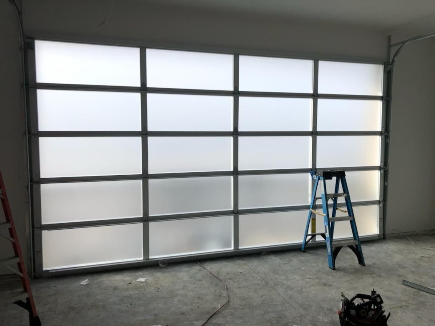 A garage door with a ladder in front of it.