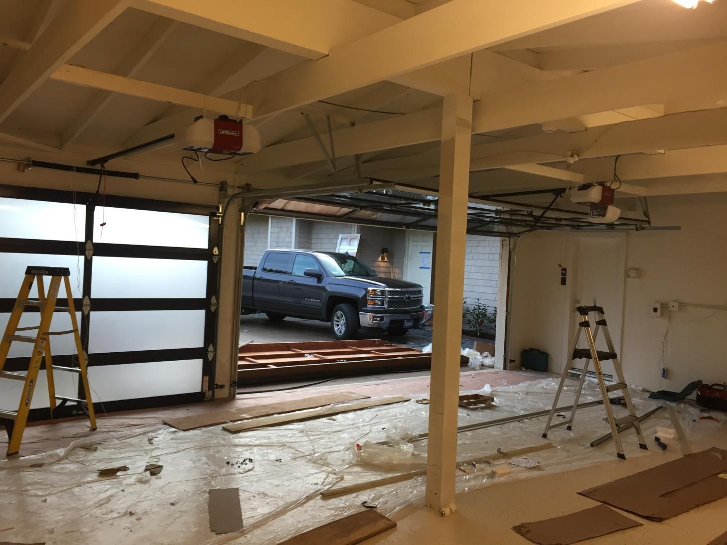 A truck is parked in a garage under construction.