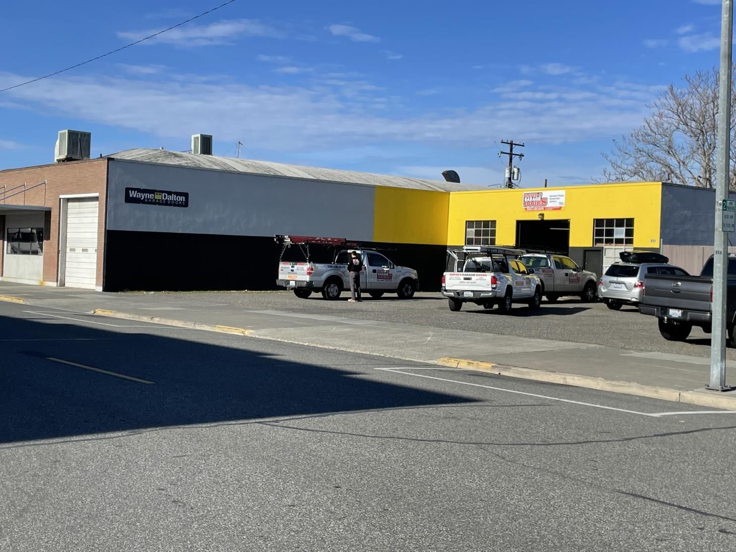 A row of trucks are parked in front of a building.