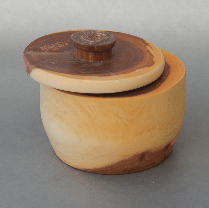 A small wooden bowl with a wooden lid
