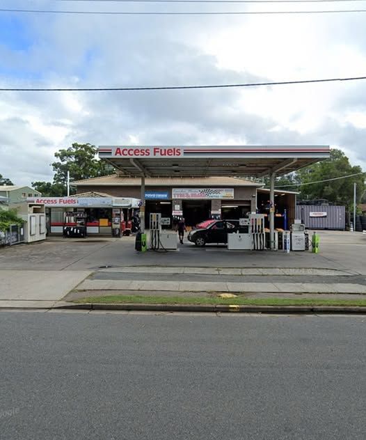 A Man Is Standing In Front Of A Sign That Says LPG Gas — Camden Haven Tyre & Brake Centre In Laurieton, NSW