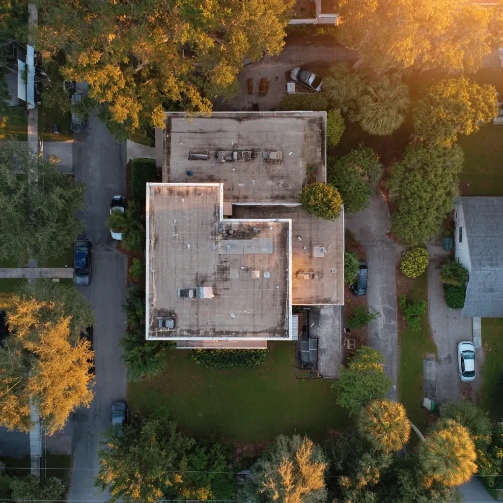 Roofing contractor Brandon FL installing white reflective membranes, thermal blocking layers, and walk pad access to rooftop units.